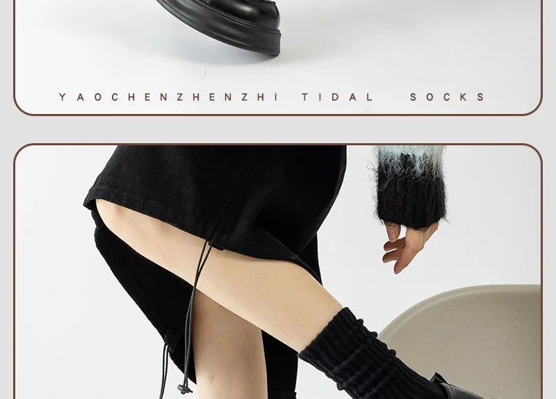 A close-up of black thick cotton tube socks being worn on a leg.