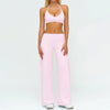 A woman wearing a pink women's premium fitness tracksuit top and matching pants.