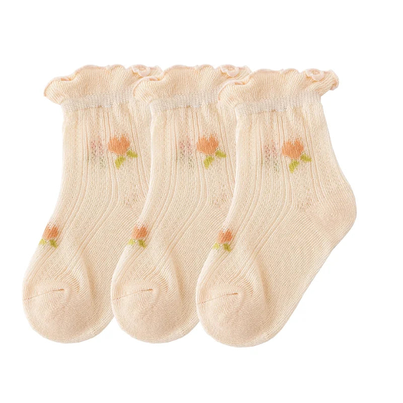 A pack of three thin, light beige summer casual baby socks for kids.