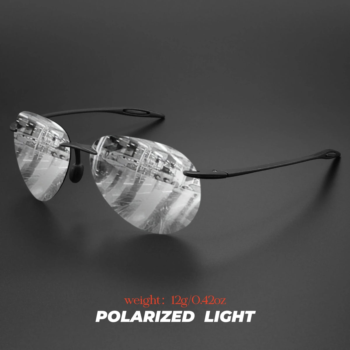 A pair of clear polarized light aviator sunglasses resting on a dark surface.