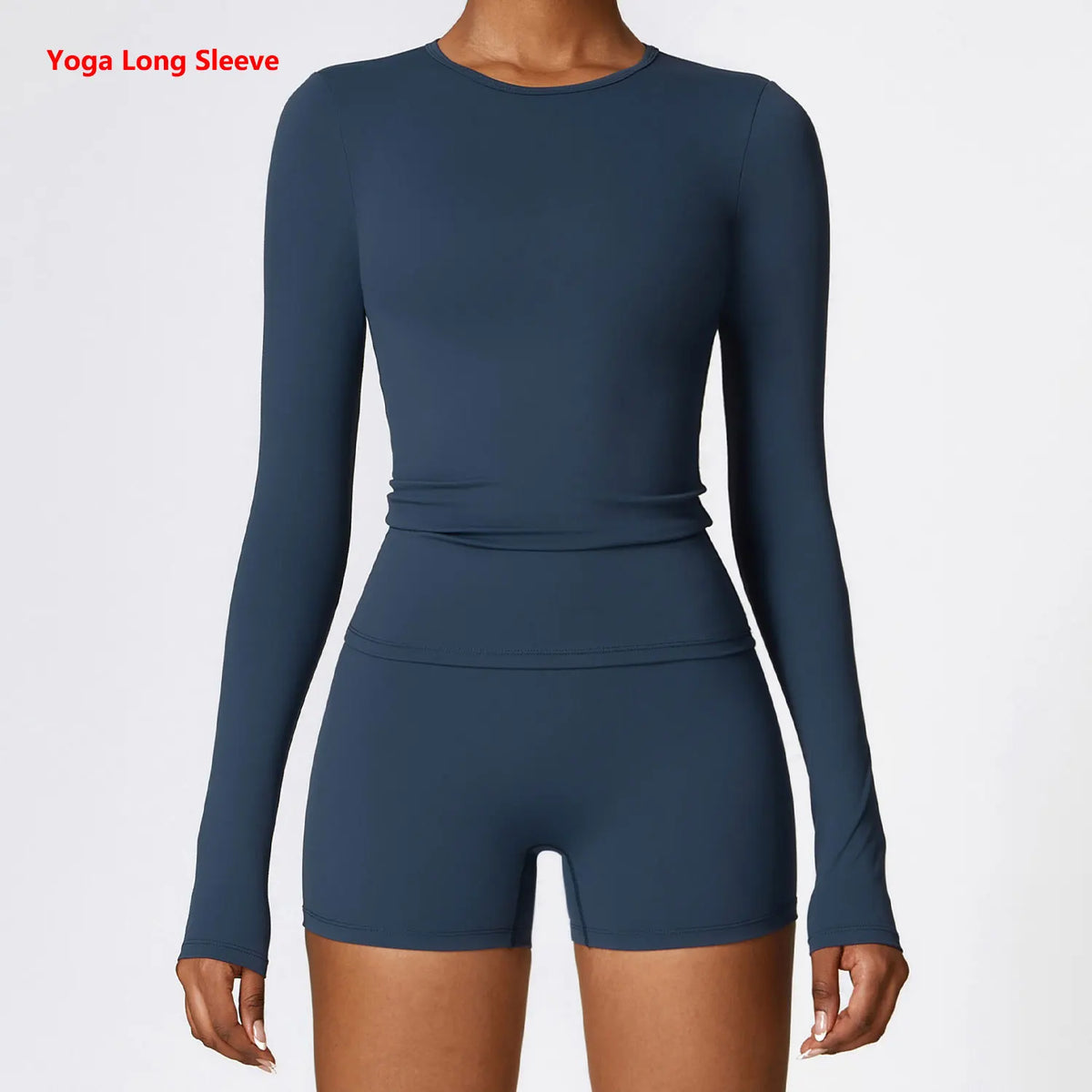 A woman wearing a navy blue long sleeve yoga and fitness t-shirt.