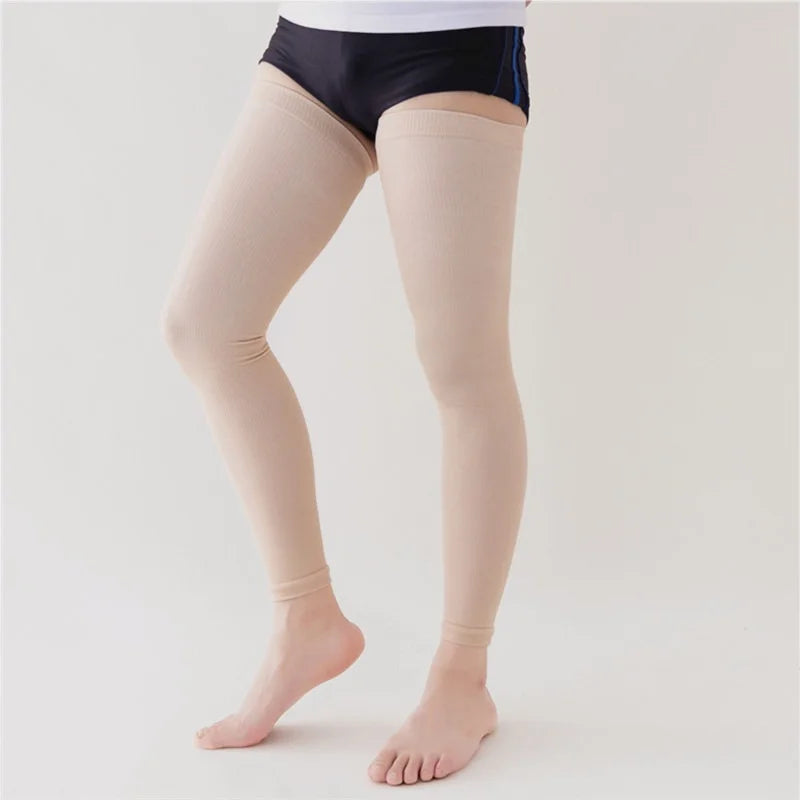 A person is wearing beige thigh-high compression socks and a black top.