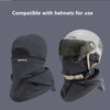 A dark gray double-layer winter beanie with a clear visor is shown next to a white helmet.