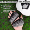 A hand holds black EVA+PP mini shin guards against a green soccer field background.