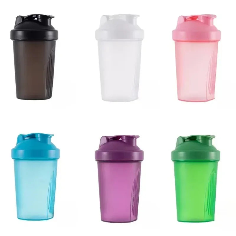 A collection of five portable protein shaker bottles in black, clear, pink, blue, purple, and green.