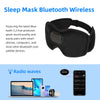 A black sleep mask featuring built-in music, shown next to a laptop and smartphone.