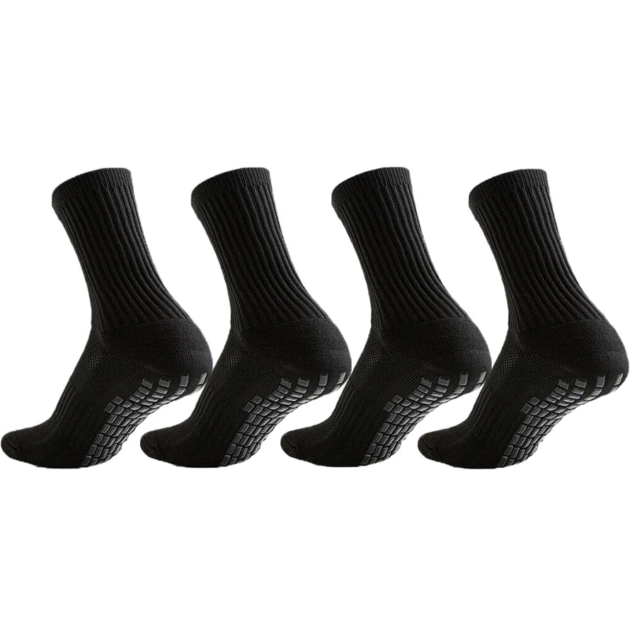A set of black athletic grip socks shown from the side.