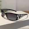 Black and white Y2K cat eye rhinestone sunglasses resting on a white surface.