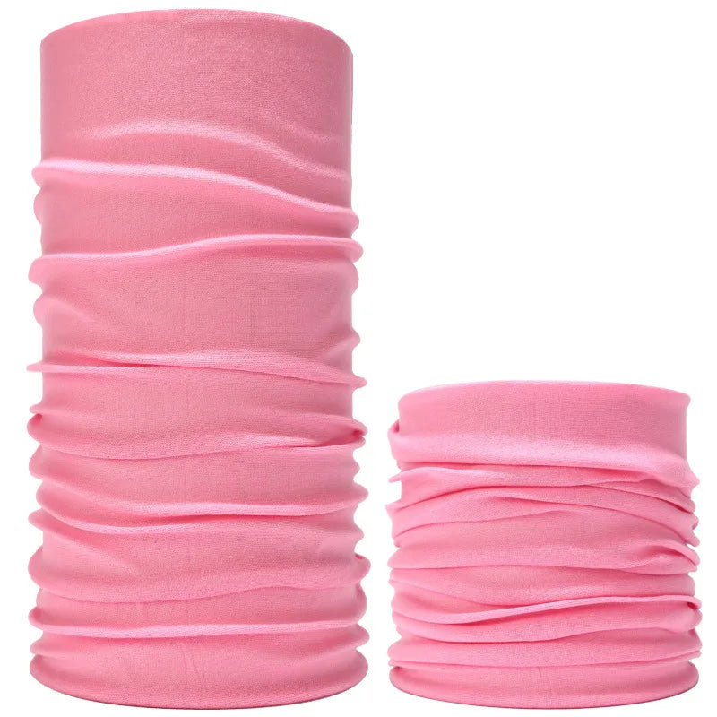 A stack of pink seamless fabric headbands and balaclavas rolled into cylindrical shapes.