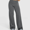 A model is wearing high waisted wide leg yoga pants in a solid gray color.