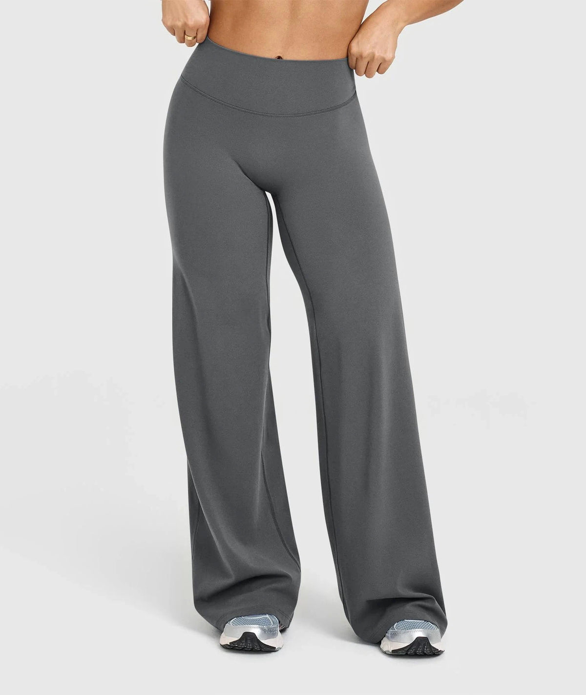 A model is wearing high waisted wide leg yoga pants in a solid gray color.