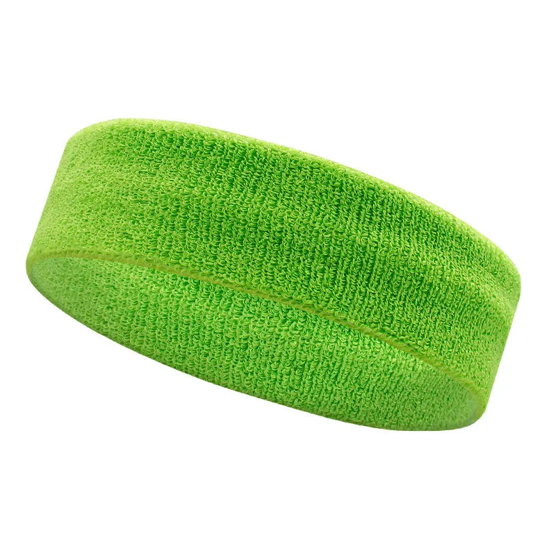 A bright lime green moisture-wicking athletic headband rolled into a cylinder.