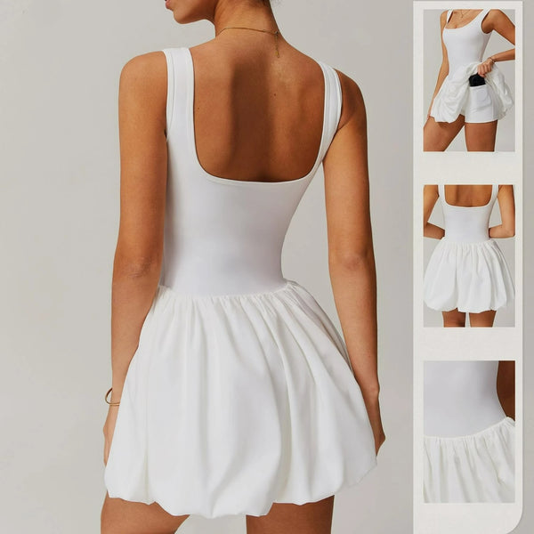 A white performance tennis dress shown from the back, featuring a fitted bodice and a pleated skirt.