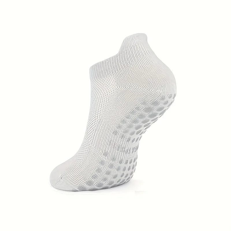 A white grip Pilates sock designed for yoga and barre, shown from the side.