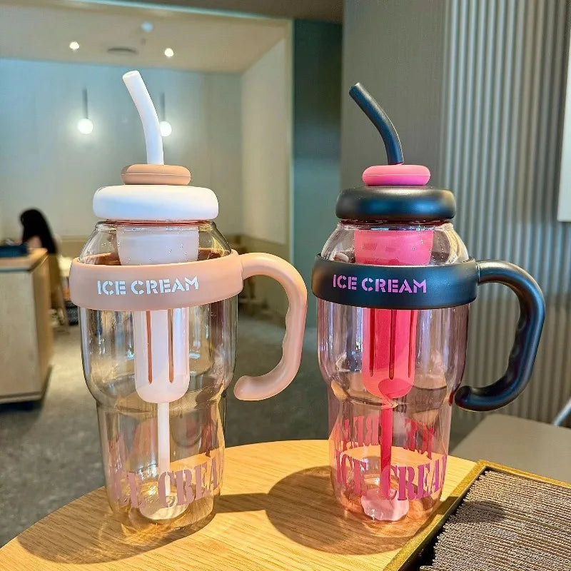 Two glass-like containers filled with pink ice cream served in plastic sports water bottles with straws