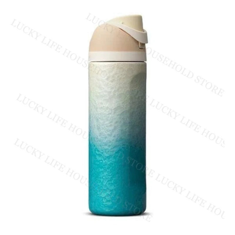 A tall insulated stainless steel sports water bottle with a light pink lid and a gradient blue-green body.