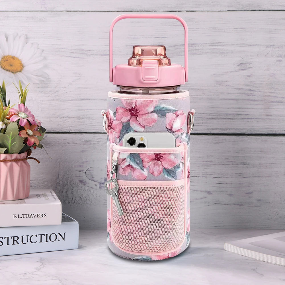 A pink water bottle sleeve with a clear bottle and a mesh pocket for a phone is displayed on a light surface.