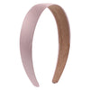 A headband featuring a smooth pink satin band and a suede-colored inner band.