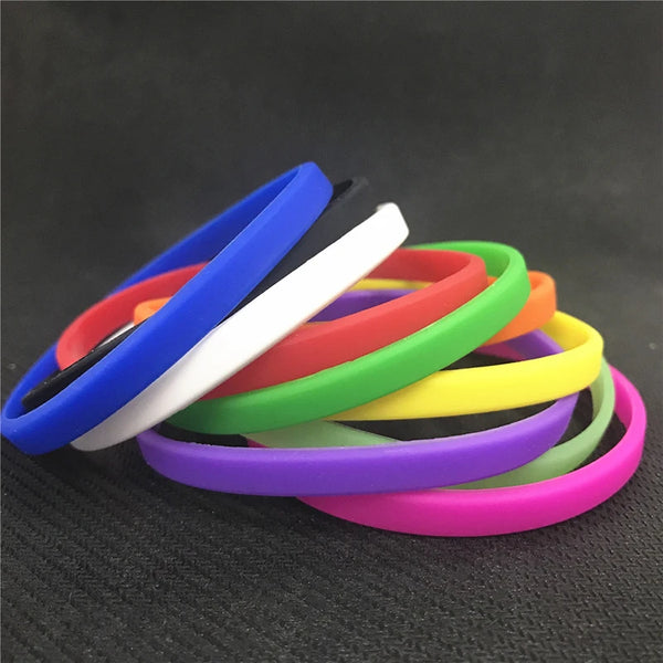 A stack of colorful silicone wristbands in various colors like blue, red, white, green, yellow, and purple.