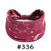 A deep magenta boho knotted cotton headband featuring celestial designs like the sun and moon.