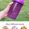 A hand holds a purple leak-proof sports shaker bottle filled with liquid on a green lawn.