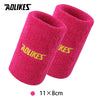A pair of bright pink silicone sport wristbands for activewear