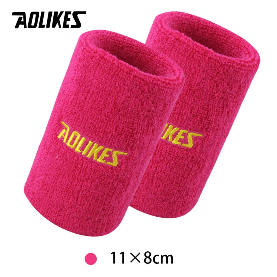 A pair of bright pink silicone sport wristbands for activewear