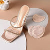 A pair of nude high heels with gold straps and anti-slip forefoot pads displayed on a light background.