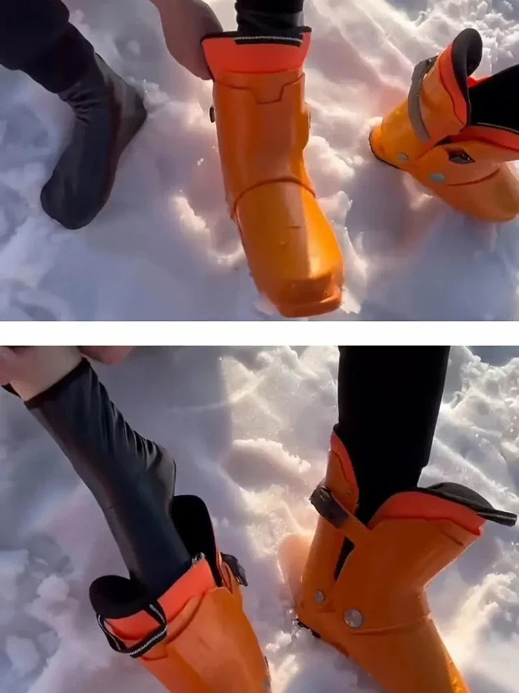 A close-up of a person's feet wearing bright orange waterproof boots in the snow.