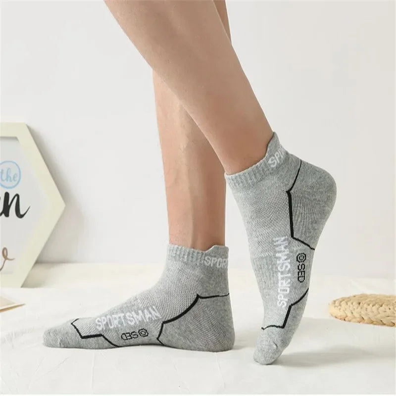 Gray men's breathable mesh performance socks displayed on a white surface.