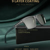 A pair of silver-framed, square polarized sunglasses resting on a black box with branding.