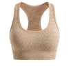 A beige seamless racerback sports bra top and matching bottom set.