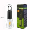 A camping lamp with a black and clear glass design is shown next to its packaging box.
