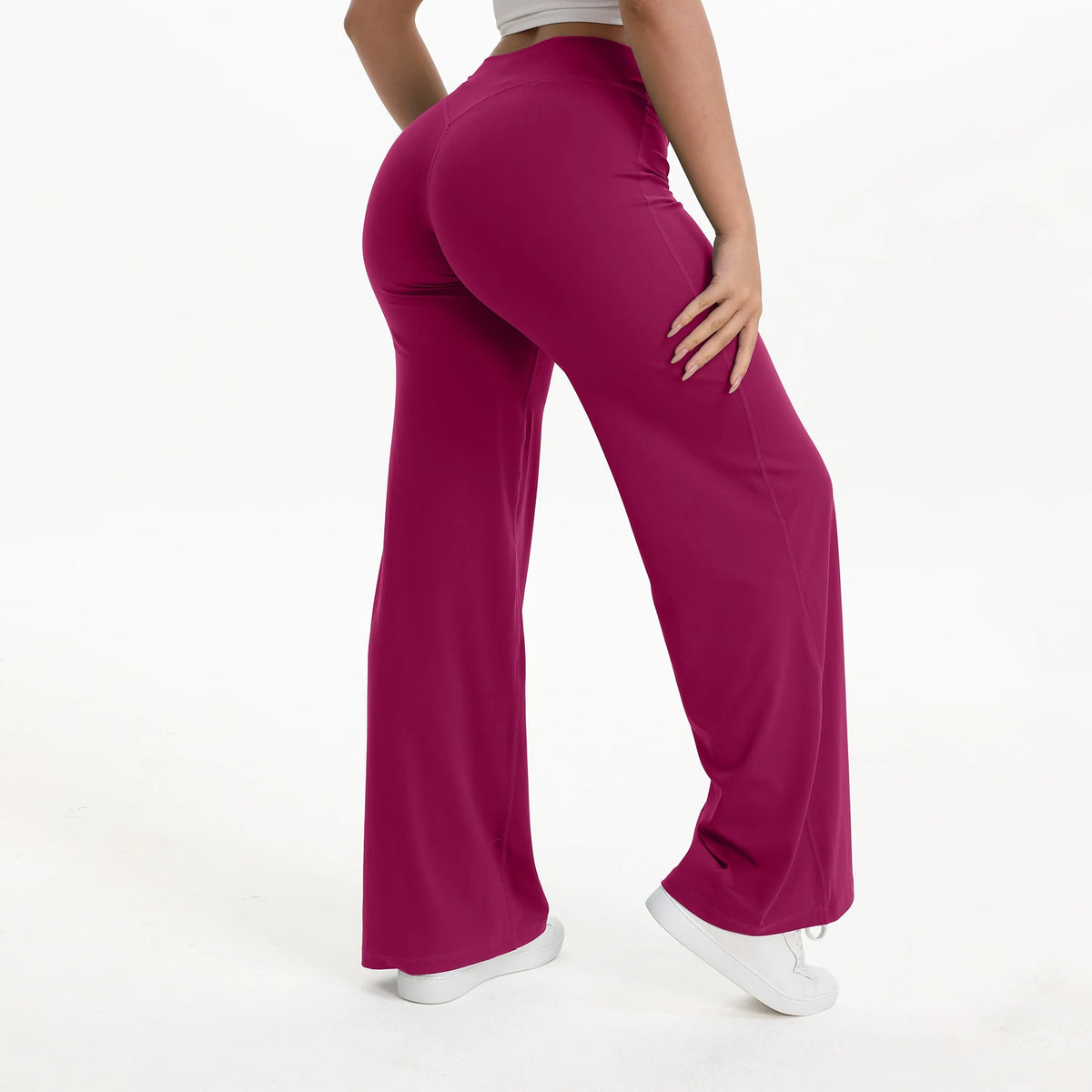 A woman wearing magenta NCLAGEN SoftMotion straight leg yoga pants