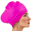 A vibrant pink silicone swim cap is shown on a model's head, highlighting its smooth texture and fit.