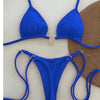 A bright royal blue halter bikini set for women displayed against a textured brown background.
