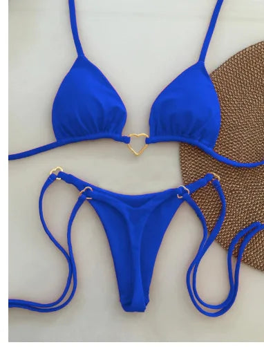A bright royal blue halter bikini set for women displayed against a textured brown background.