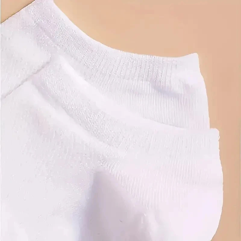 A close-up view of white comfort fit ankle socks folded or displayed against a light background.