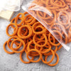 A pile of 50 pieces of mixed color elastic hair bands in orange and brown are displayed on a gray surface.