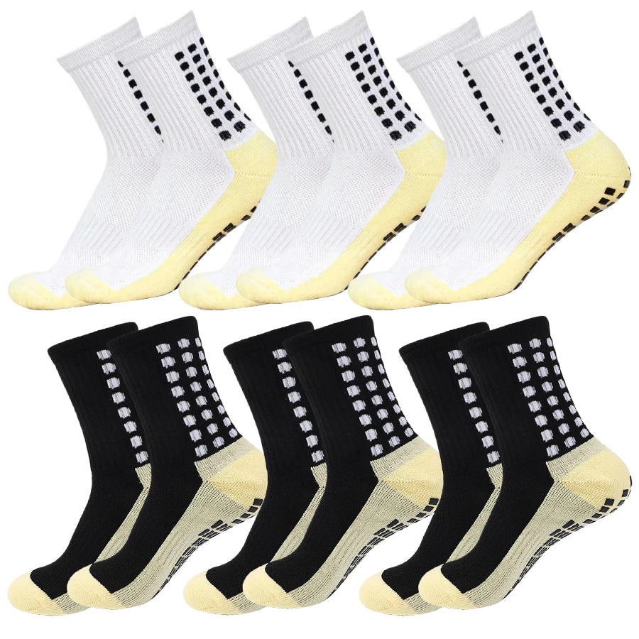 A set of white and black non-slip grip socks for sports, shown from the side.