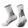 A pair of white athletic sports socks with black chevron and striped patterns.