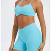 A model wearing light blue seamless high-waist yoga leggings and a matching sports bra top.