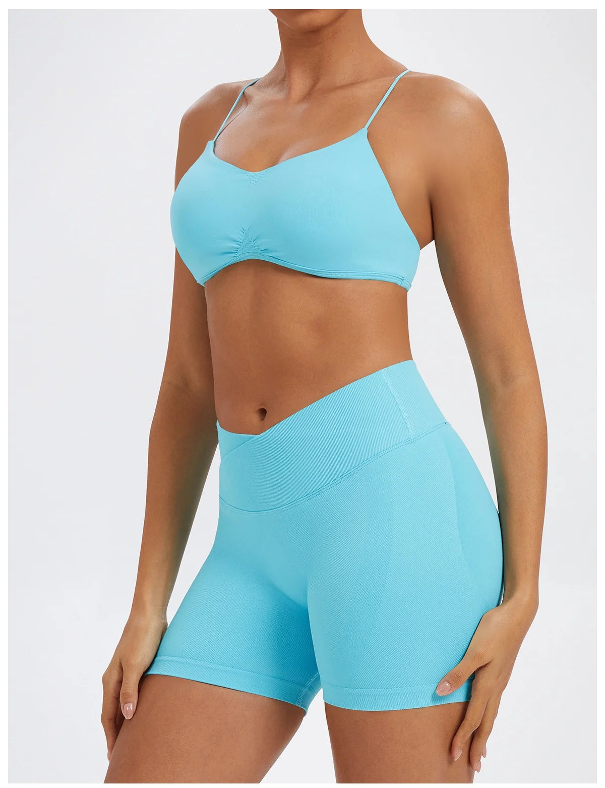 A model wearing light blue seamless high-waist yoga leggings and a matching sports bra top.