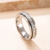 A silver stainless steel ring featuring a band set with clear cubic zirconia gemstones.