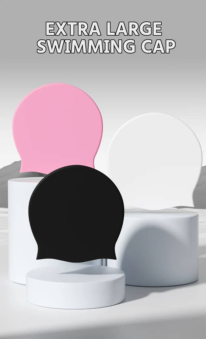 Extra large swimming cap shown in pink, black, and white on display stands.