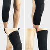 Black compression knee pads shown on a model's leg, demonstrating the fit and design.