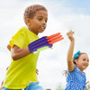A young boy is playing with an orange carrot fidget stress relief toy outdoors.