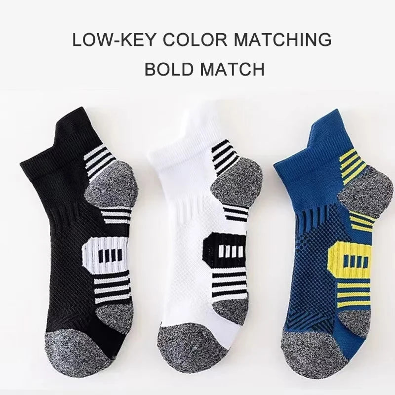Three pairs of low-key color matching bold athletic socks in black, white, and blue patterns.