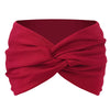 A deep red twisted criss cross elastic headband for yoga and sports.