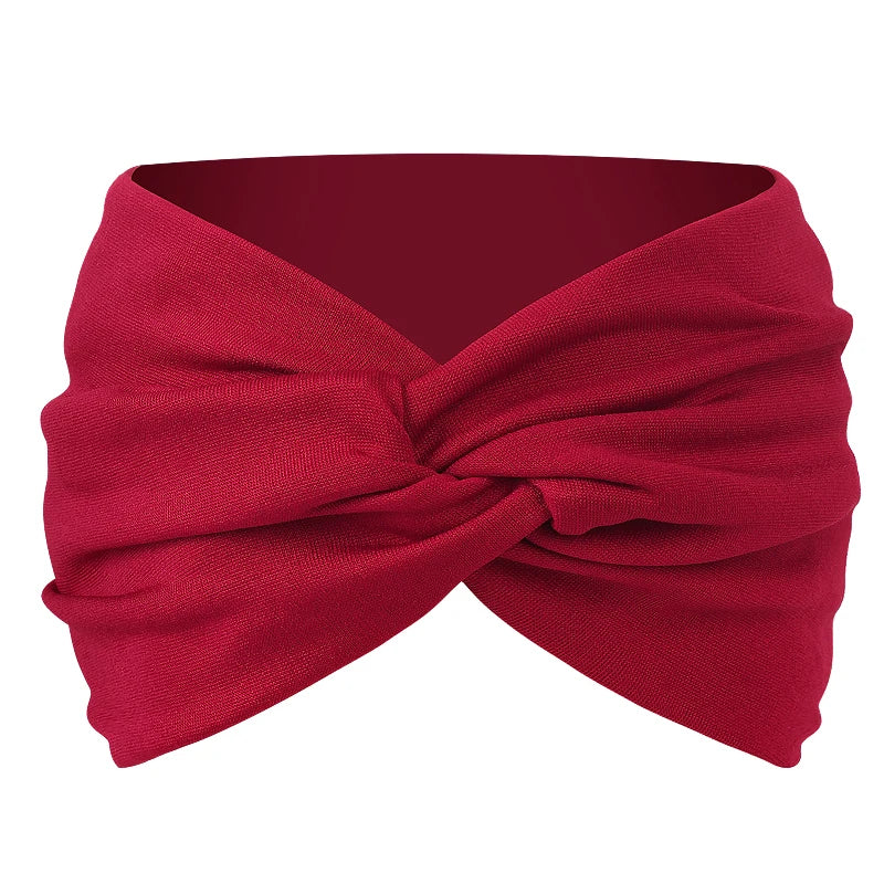 A deep red twisted criss cross elastic headband for yoga and sports.